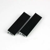 Pair of black aluminum woodworking vise jaw pads with textured grip on white background
