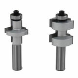 Two silver tongue and groove router bits for woodworking on white background