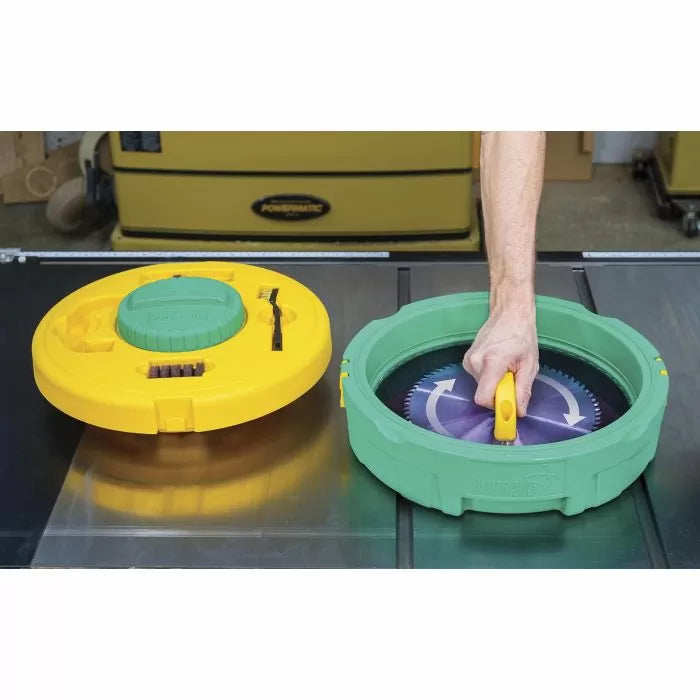 Person cleaning circular saw blade with twist-action blade cleaning tool in workshop