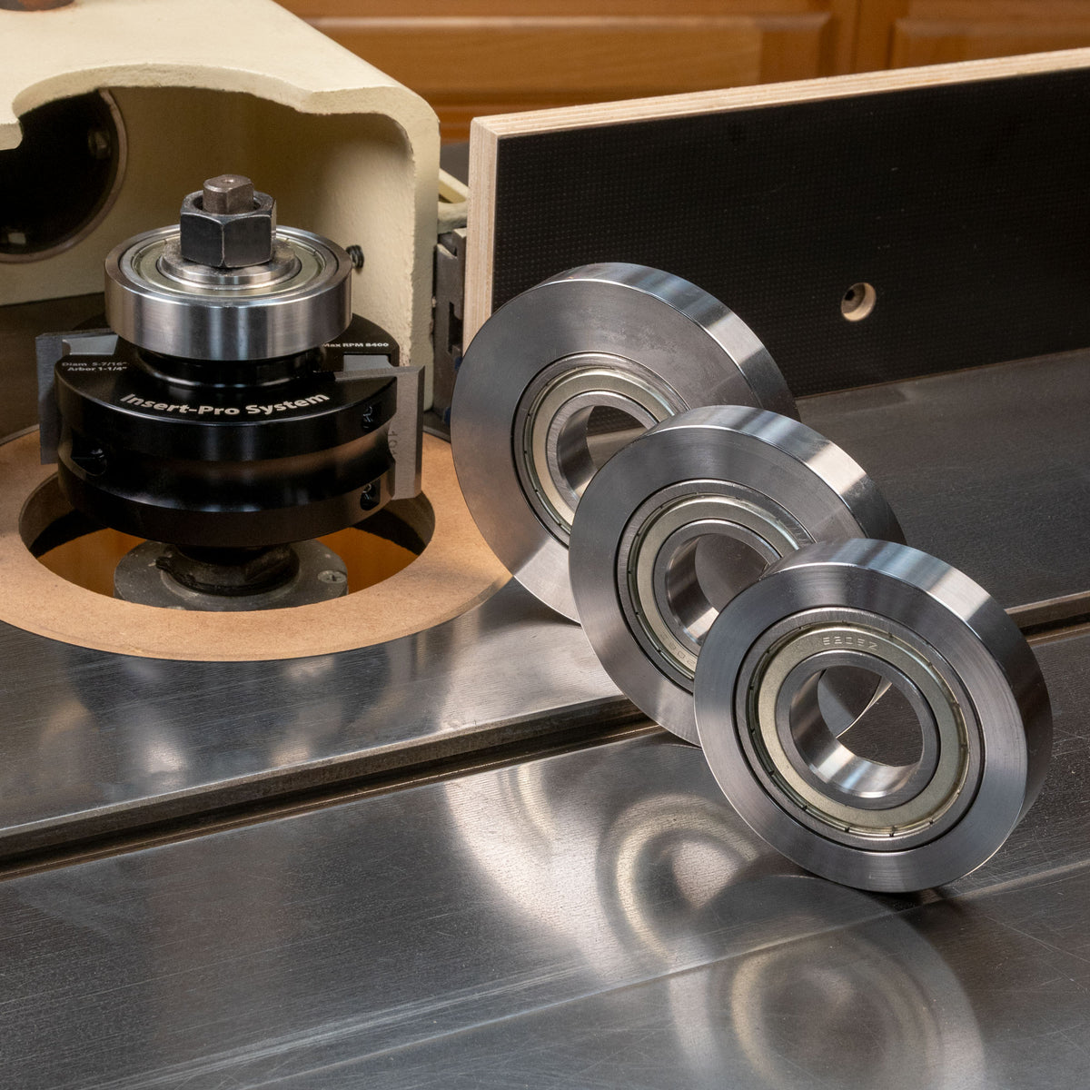 Insert-Pro shaper cutter on spindle with three metal router cutter bearings on table