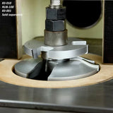 Close-up of a shaper cutter head installed on a woodworking router table