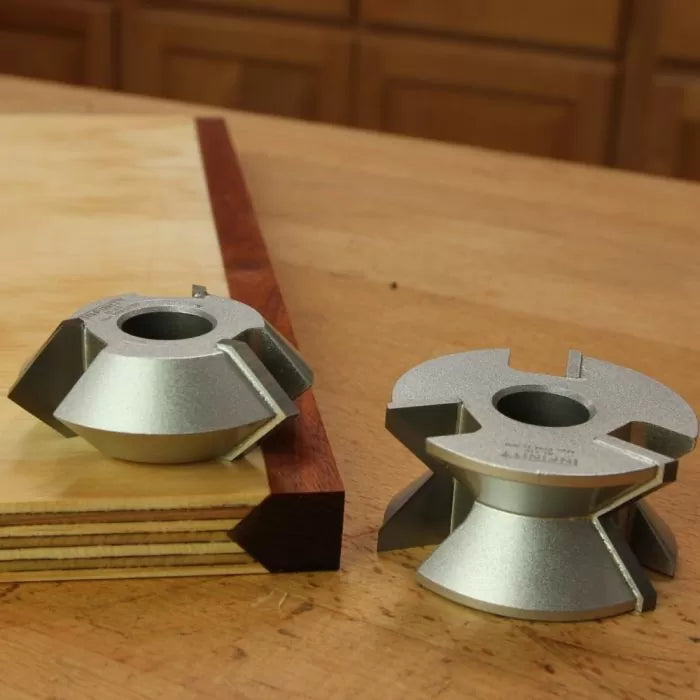 Carbide-tipped woodworking panel cutters displayed on a wooden workbench