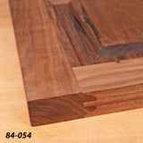 Close-up of a walnut woodworking joint on a tabletop with dovetail joinery detail
