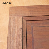 Close-up of a wooden cabinet door corner joint with visible dowels and smooth wood grain