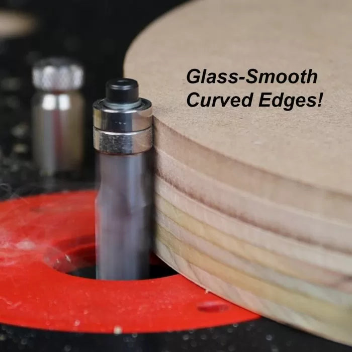 Flush trim router bit smoothing the curved edges of plywood on a router table.