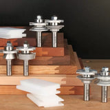 Carbide joinery router bits set displayed on stacked hardwood boards with sample joints.