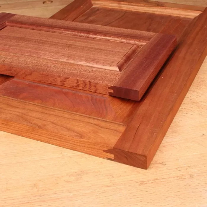 Wooden cabinet doors with box joint corners on a workbench, woodworking project