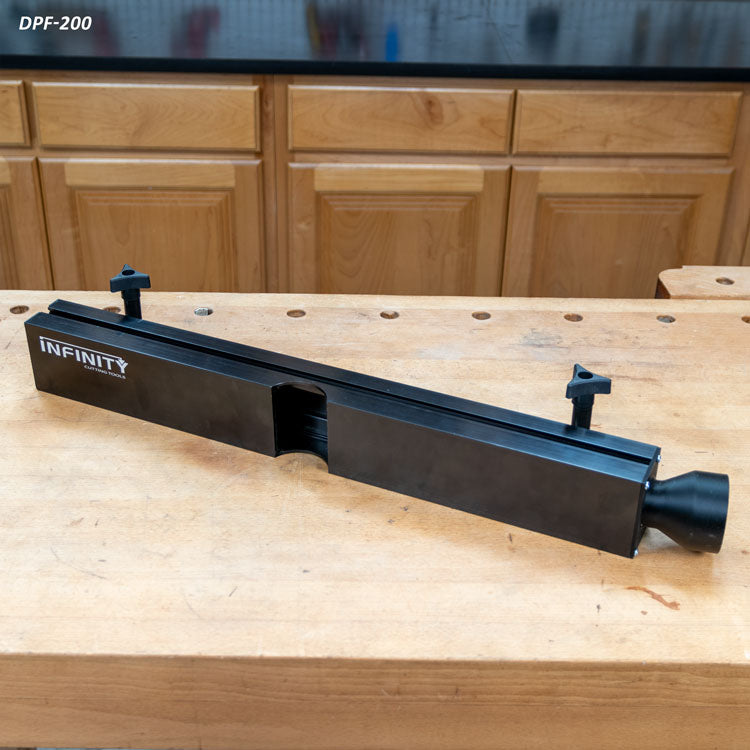 Router table dust collection fence on woodworking bench with mounting knobs, black finish