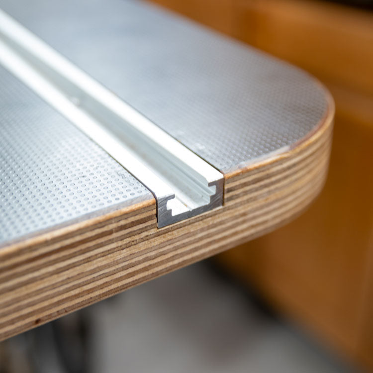 Router table top with aluminum miter track rail for woodworking