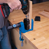 Pocket hole jig clamped to workbench with drill driving screw into wood joinery setup