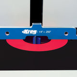 Router table setup with blue Kreg measuring guide, red insert plate, and router bit