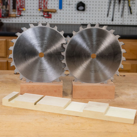 Two flat top blades on a work bench.