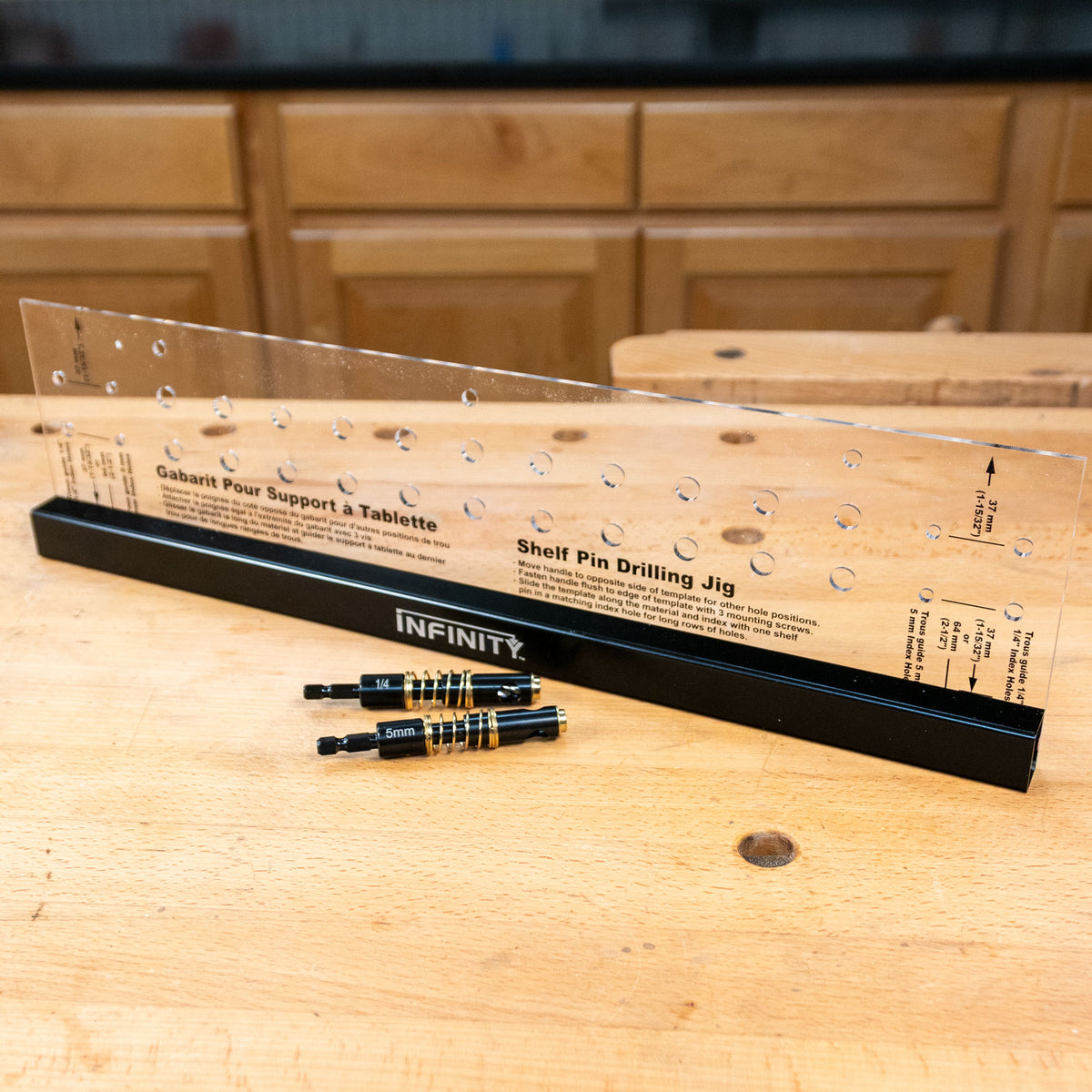 Shelf pin drilling jig with clear template and drill bits on a woodworking bench
