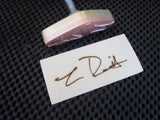Signature branding iron with engraved custom wood burn mark on light wood piece