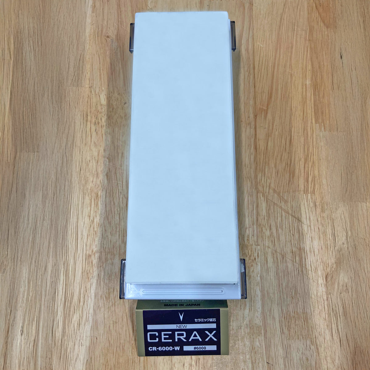 Cerax 6000 grit sharpening stone on wood surface, ideal for fine tool honing