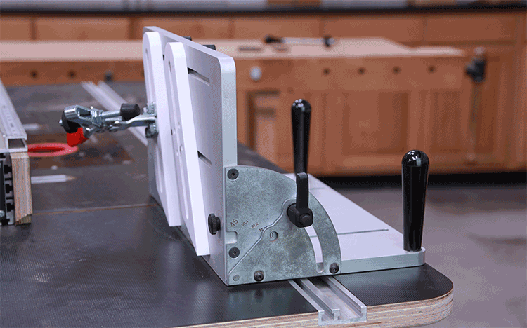 Adjustable woodworking table saw fence jig in workshop setting, demonstrating angle changes
