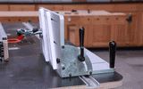 Adjustable woodworking table saw fence jig in workshop setting, demonstrating angle changes