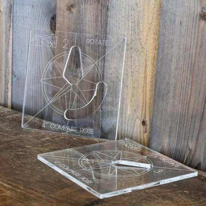 Acrylic compass rose woodworking template with engraved markings on wooden surface