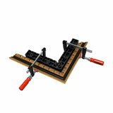 Corner clamping jig holding ornate picture frame for precise woodworking and assembly