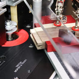 Woodworking router table setup with clamps and router bit cutting wood for joinery