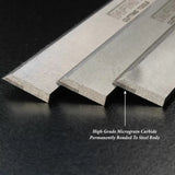 Carbide-tipped woodworking planer blades showing micrograin edges on a black surface.