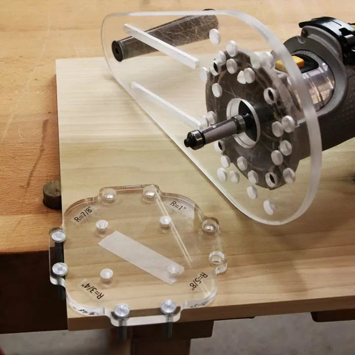 Acrylic router template and base plate on a woodworking table, precision routing tool setup