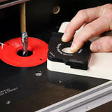 Woodworker using a corner radius guide on a router table with a router bit installed