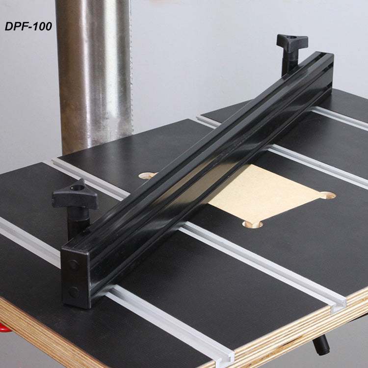 Aluminum drill press fence mounted on a woodworking drill press table with T-tracks.