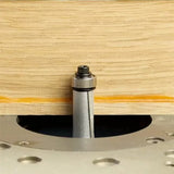 Carbide flush trim router bit cutting plywood on a router table, woodworking tool close-up