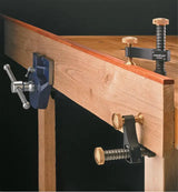 Woodworking bench with vise and clamping tools for precise woodwork and secure holding