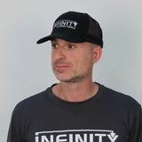 Man wearing black Infinity Cutting Tools mesh trucker hat and matching logo t-shirt