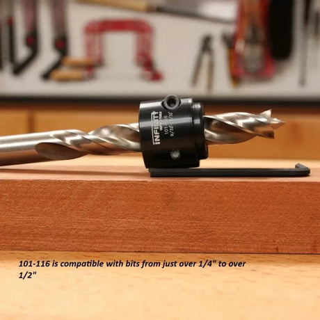 Adjustable drill bit depth stop collar on a wood board in a woodworking shop.