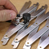 Hand adjusting metal woodworking marking gauge tool on wooden surface