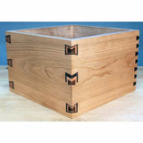 Handcrafted wooden box with decorative butterfly inlay and dovetail joints, on workbench