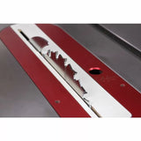 Close-up of a table saw blade set in a red and silver insert plate for woodworking