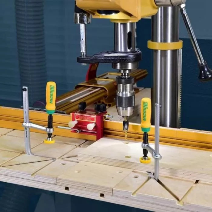 Matchfit jig system clamped to a drill press table for precise woodworking drilling.