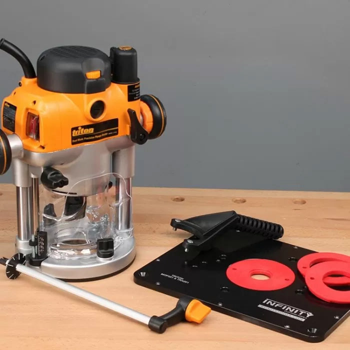 Woodworking router with router table insert plate and accessories on workbench