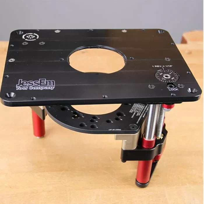 Precision router lift for woodworking with black plate and adjustment dial on a workbench