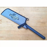 Protective saw blade sleeve with handle on wood surface, labeled Shark Corp.