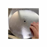 Hand holding a circular saw blade for woodworking on a metal surface