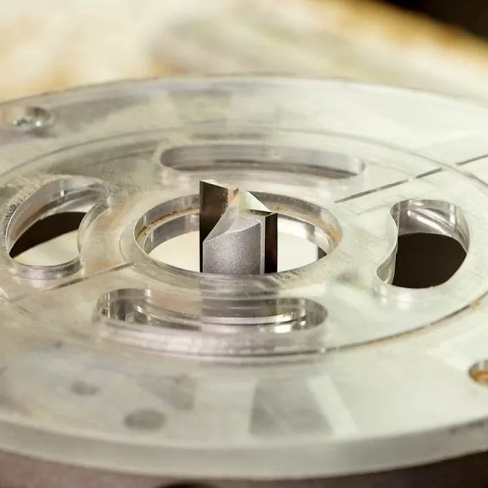 Straight router bit installed in a clear router base, woodworking tool close-up