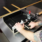 Table saw crosscut sled with clamp in use, cutting wood strips for woodworking precision.