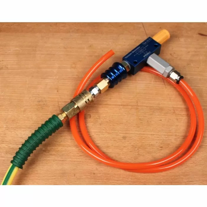 Woodworking compressed air hose kit with connectors and fittings on a workbench