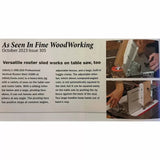 Professional vertical router sled in use on a table saw, featured in woodworking magazine.