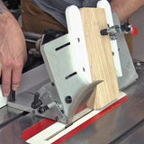 Table saw tenon jig holding a wood piece for precise woodworking cut